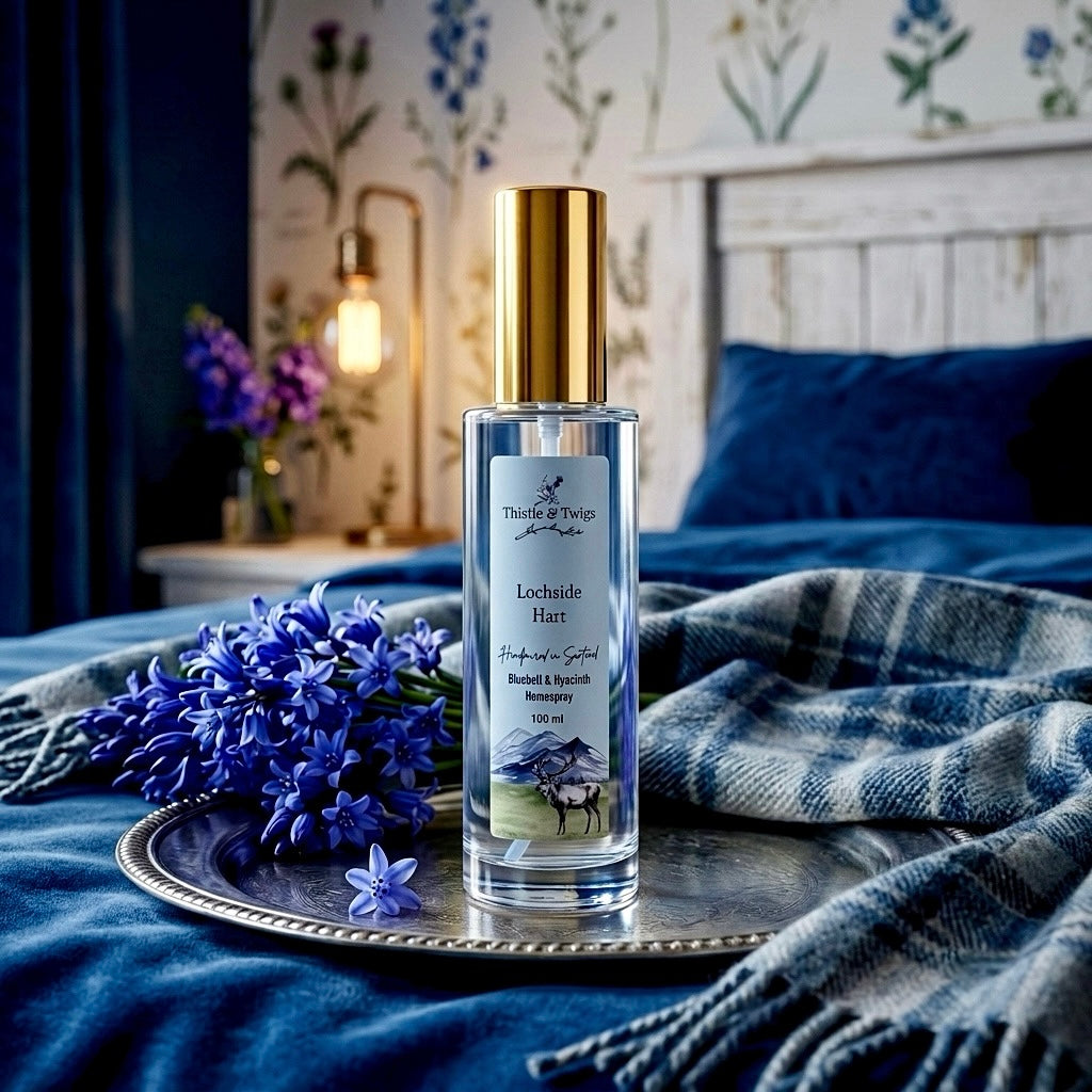 Thistle & Twigs Lochside Hart 100ml bluebell and hyacinth home spray on a silver tray with Scottish tartan throw and bluebells in a cosy bedroom setting